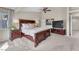 Well-lit main bedroom with a carpeted floor, ceiling fan, and a dark wood bed frame at 5868 Revital Ct, Las Vegas, NV 89131