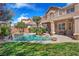 Private backyard oasis featuring a swimming pool with rock accents and mature landscaping at 5868 Revital Ct, Las Vegas, NV 89131