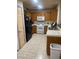 Traditional kitchen featuring wood cabinets, white appliances, tile countertops and tiled backsplash at 5875 Rainbow Bridge Dr, Las Vegas, NV 89142