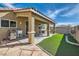 An inviting covered patio and artificial grass complete the backyard space at 6035 Eganridge Ct, North Las Vegas, NV 89081