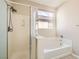 Well-lit bathroom with a separate shower and tub, window, and neutral color scheme at 6035 Eganridge Ct, North Las Vegas, NV 89081