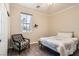 Inviting bedroom with wood floors, a chair, and natural light from the large window at 6035 Eganridge Ct, North Las Vegas, NV 89081