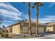 Charming single-story home with desert landscaping, tile roof, and palm trees in a sunny neighborhood at 6035 Eganridge Ct, North Las Vegas, NV 89081