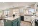 Spacious kitchen featuring tile floors, white cabinets, and a center island with a stylish breakfast bar at 6035 Eganridge Ct, North Las Vegas, NV 89081