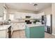 Bright kitchen with white cabinetry, stainless steel appliances, and a functional center island at 6035 Eganridge Ct, North Las Vegas, NV 89081