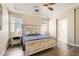 Main bedroom showcasing tray ceiling, wood floors, and large bed with nightstands at 6035 Eganridge Ct, North Las Vegas, NV 89081