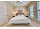 Neutral bedroom with a ceiling fan and two windows at 65 Luce Del Sole # 1, Henderson, NV 89011