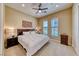 Well-lit bedroom featuring a ceiling fan, two windows and neutral decor at 65 Luce Del Sole # 1, Henderson, NV 89011