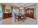 Elegant dining room featuring a large wooden table, ornate china cabinet, and sliding glass doors at 65 Luce Del Sole # 1, Henderson, NV 89011