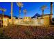 Impressive community entrance featuring a water feature and desert landscaping at 65 Luce Del Sole # 1, Henderson, NV 89011