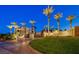 Elegant community entrance with palm trees and manicured landscaping at 65 Luce Del Sole # 1, Henderson, NV 89011