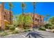 Southwest townhome displays mature landscaping with desert trees, plants, and a barrel-tile roof at 65 Luce Del Sole # 1, Henderson, NV 89011