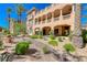 Multi-story villa with a grand covered patio and well-maintained desert landscaping at 65 Luce Del Sole # 1, Henderson, NV 89011