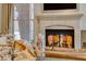 Close-up of a fireplace with seashells in front, adding a nautical touch to the living space at 65 Luce Del Sole # 1, Henderson, NV 89011