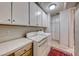 Laundry room with washer, dryer and plenty of cabinet space at 65 Luce Del Sole # 1, Henderson, NV 89011