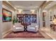 Inviting living room featuring armchairs, hardwood floors, and a built in bookcase at 65 Luce Del Sole # 1, Henderson, NV 89011