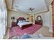 Large main bedroom featuring a ceiling fan, ensuite bathroom, and a decorative area rug at 65 Luce Del Sole # 1, Henderson, NV 89011