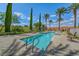 Sparkling rectangular pool surrounded by mature landscaping and lounge chairs at 65 Luce Del Sole # 1, Henderson, NV 89011