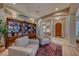 Inviting sitting room with built-in bookshelves and plush armchairs, creating a cozy retreat at 65 Luce Del Sole # 1, Henderson, NV 89011