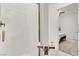 Modern bathroom showcasing a glass-enclosed shower with elegant bronze fixtures and white subway tile at 6618 Palm Branch St, North Las Vegas, NV 89086