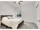 Bedroom with a window, ceiling fan, and neutral carpeting at 6618 Palm Branch St, North Las Vegas, NV 89086