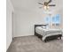 Cozy bedroom with plush carpet, ceiling fan, and bright natural light from the window at 6618 Palm Branch St, North Las Vegas, NV 89086