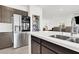 Modern kitchen featuring stainless steel refrigerator, pantry and quartz counters at 6618 Palm Branch St, North Las Vegas, NV 89086