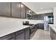 Modern kitchen with stainless steel appliances, quartz countertops, and ample cabinet space at 6618 Palm Branch St, North Las Vegas, NV 89086