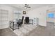 Functional home office with a large desk, chair, shelving and natural light, perfect for productivity at 6618 Palm Branch St, North Las Vegas, NV 89086