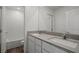 Bathroom featuring a double sink vanity with stone countertops and a shower over tub with white subway tile at 6773 Violet Cascade Ave, Las Vegas, NV 89156