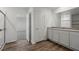 Bathroom featuring double sinks, wood look flooring and a glass enclosed shower at 6773 Violet Cascade Ave, Las Vegas, NV 89156