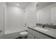 Bright bathroom featuring a shower-over-tub, white subway tiles, and a sleek vanity with a stone countertop at 6773 Violet Cascade Ave, Las Vegas, NV 89156