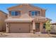 Charming two-story home featuring a brick driveway and a tan exterior at 6773 Violet Cascade Ave, Las Vegas, NV 89156