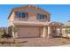 Charming two-story home featuring a brick driveway and a tan exterior at 6773 Violet Cascade Ave, Las Vegas, NV 89156