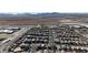 Extensive aerial shot capturing the layout of a residential community in a desert environment with mountain views at 6832 Upland Heights Ave, Las Vegas, NV 89142