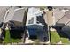 Aerial view of a backyard featuring green grass, gray concrete, with solar panels installed on the roof at 6832 Upland Heights Ave, Las Vegas, NV 89142