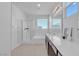 Clean bathroom featuring double sinks, a walk-in shower and a bathtub with natural light at 6832 Upland Heights Ave, Las Vegas, NV 89142