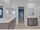 Bright bathroom featuring double vanities, large mirrors, and an adjacent bedroom at 6832 Upland Heights Ave, Las Vegas, NV 89142