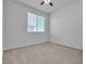 Clean, carpeted bedroom features neutral walls, natural light, and a ceiling fan at 6832 Upland Heights Ave, Las Vegas, NV 89142