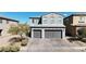 Two-story home featuring a three car garage and manicured landscaping at 6832 Upland Heights Ave, Las Vegas, NV 89142