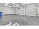 Spacious garage featuring an epoxy floor and two garage doors at 6832 Upland Heights Ave, Las Vegas, NV 89142