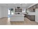 Bright kitchen featuring stainless steel appliances, kitchen island, and a sliding door at 6832 Upland Heights Ave, Las Vegas, NV 89142