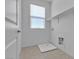 Bright laundry room features neutral walls, overhead shelving, and modern fixtures at 6832 Upland Heights Ave, Las Vegas, NV 89142