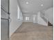 Bright living room featuring tile entry, carpeted floors and staircase at 6832 Upland Heights Ave, Las Vegas, NV 89142