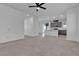 Open-concept living area with neutral carpet, white walls, and ample natural light at 6832 Upland Heights Ave, Las Vegas, NV 89142