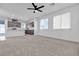 Open concept living room flows into a modern kitchen with sleek countertops and stainless steel appliances at 6832 Upland Heights Ave, Las Vegas, NV 89142