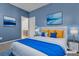 Staged bedroom with blue walls, matching decor, and an ensuite bathroom at 6832 Upland Heights Ave, Las Vegas, NV 89142