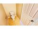 Small bathroom features a toilet, tile flooring, and a standard door at 7244 Buglehorn St, Las Vegas, NV 89131