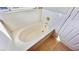 Clean white bathtub with white tile surround and updated fixtures at 7244 Buglehorn St, Las Vegas, NV 89131