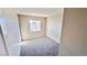 Neutral bedroom with carpeted floor, bright window, and electrical outlets at 7244 Buglehorn St, Las Vegas, NV 89131